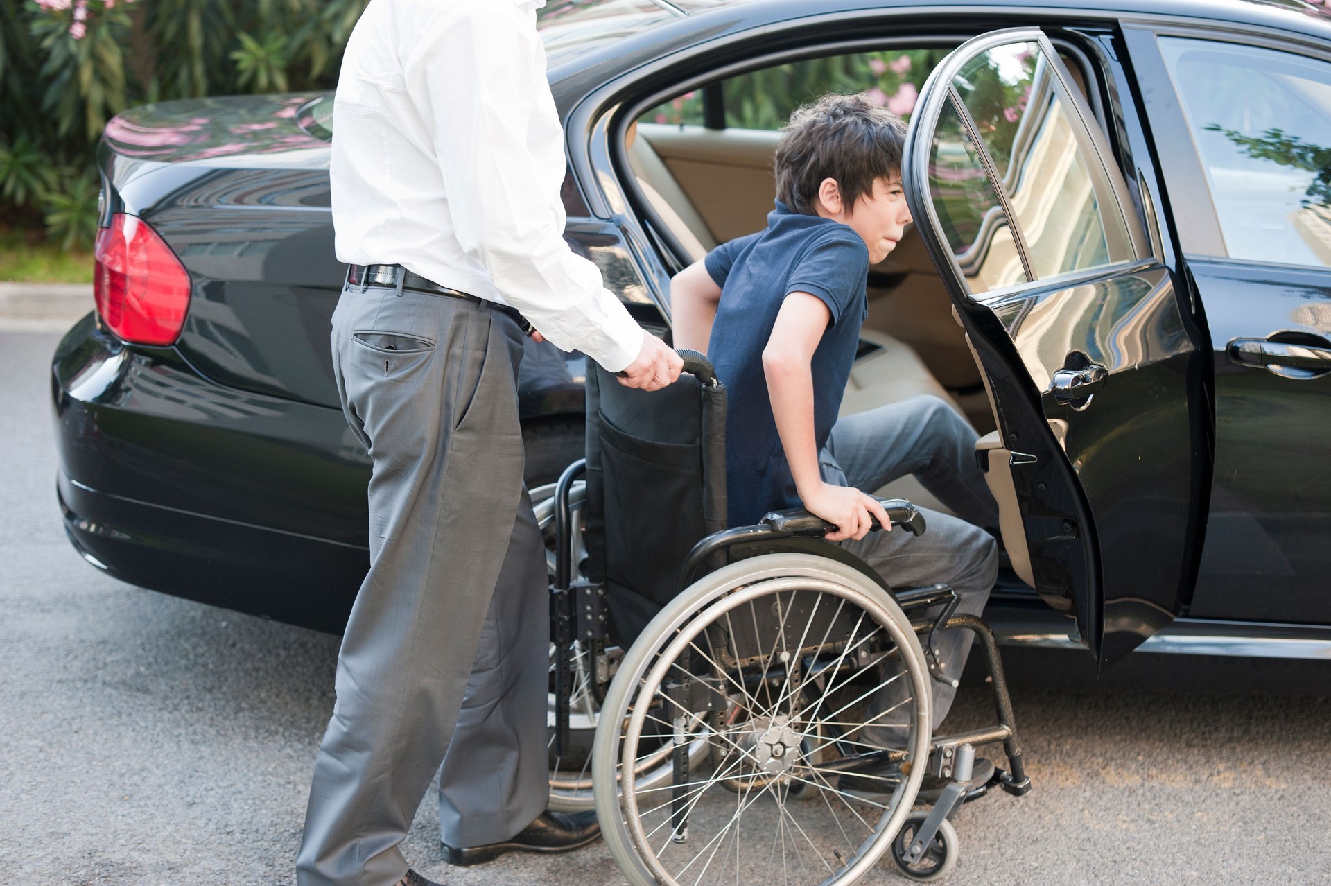 Young Boy in Wheelchair Transferring to Car